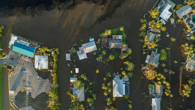 Aftermath of natural disaster Flooded houses by hurricane Ian rainfall in Florida residential area shutterstock 2464986729
